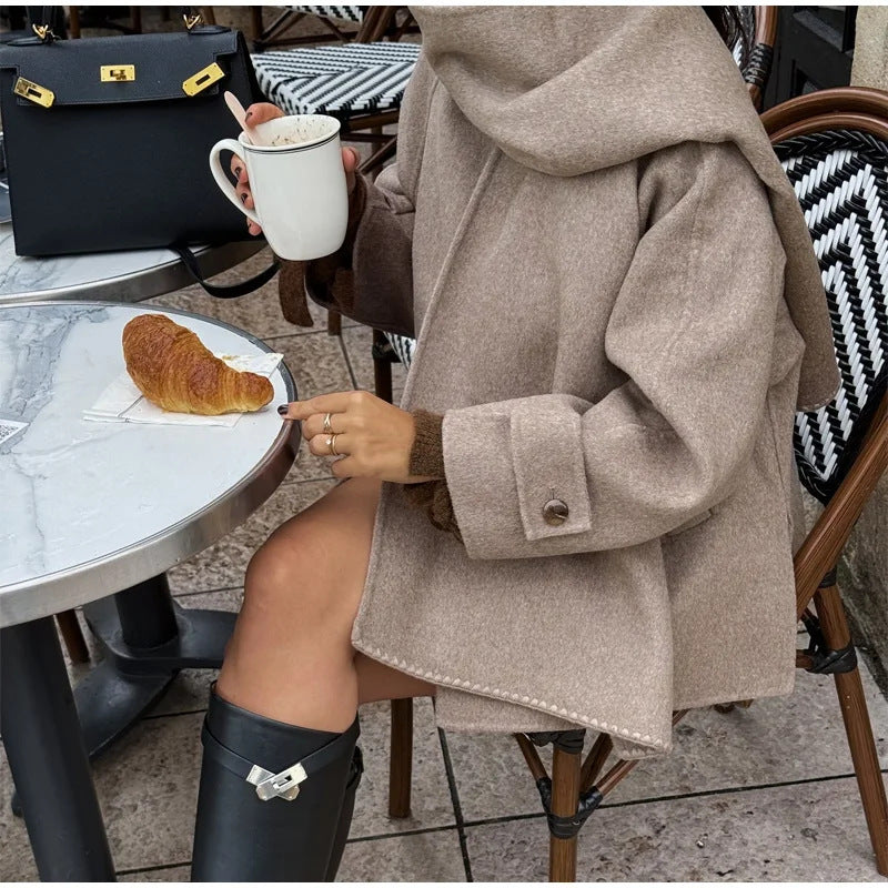 Women's oversized casual winter jacket with hood and front button closure