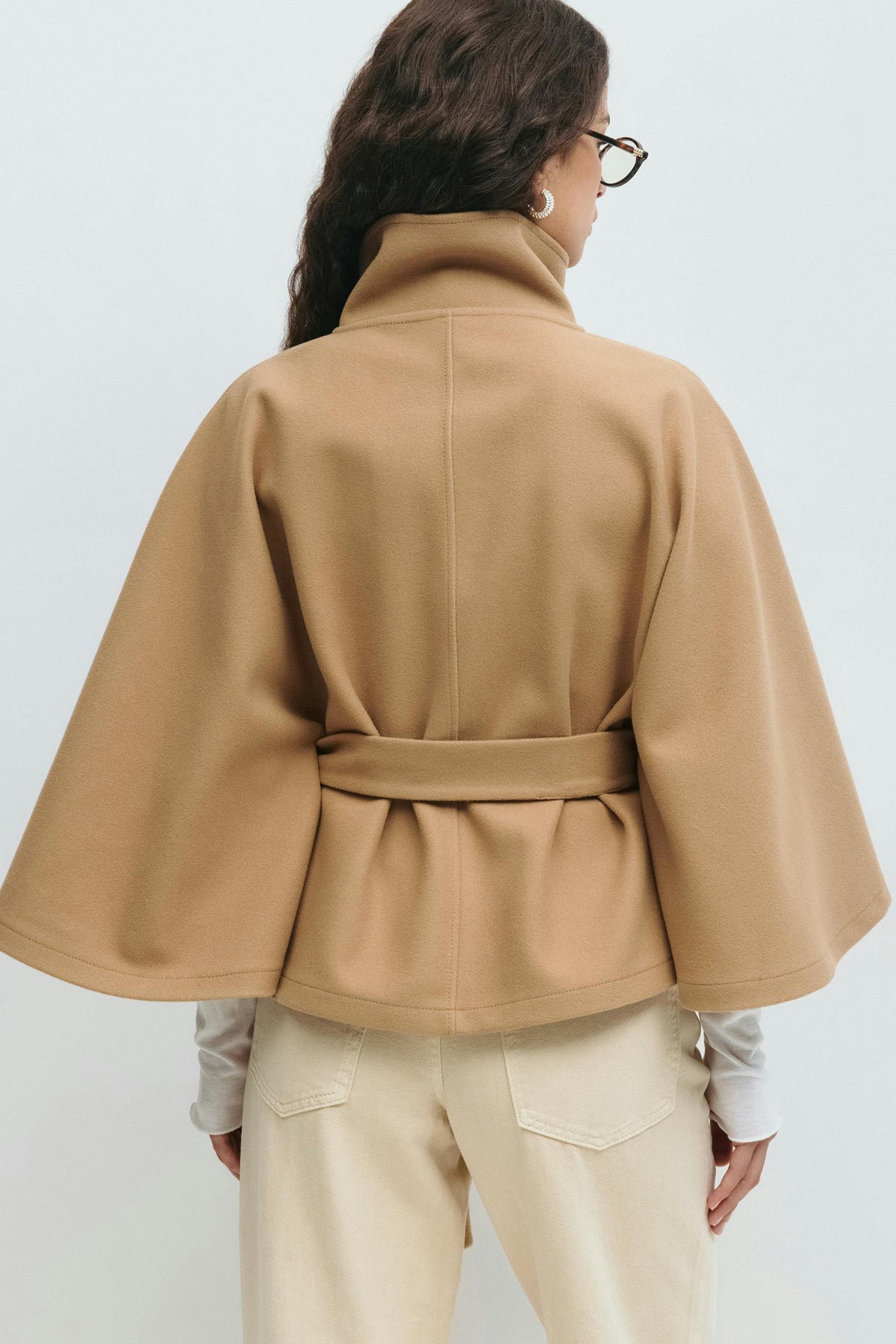Women’s cape coat with high collar, tie belt, and regular fit