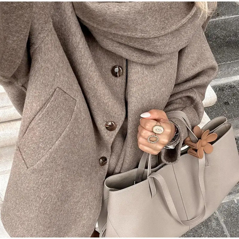 Women's oversized casual winter jacket with hood and front button closure
