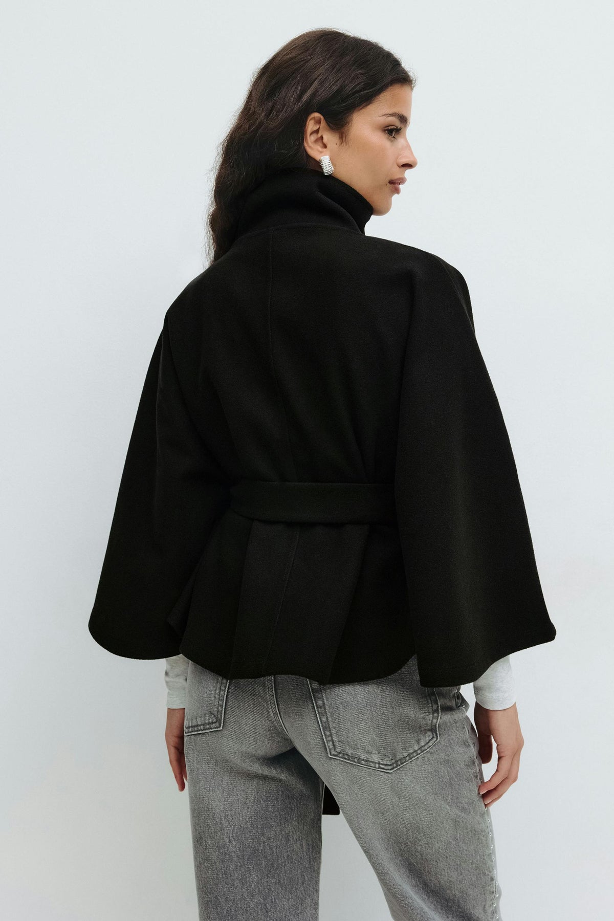 Women’s cape coat with high collar, tie belt, and regular fit