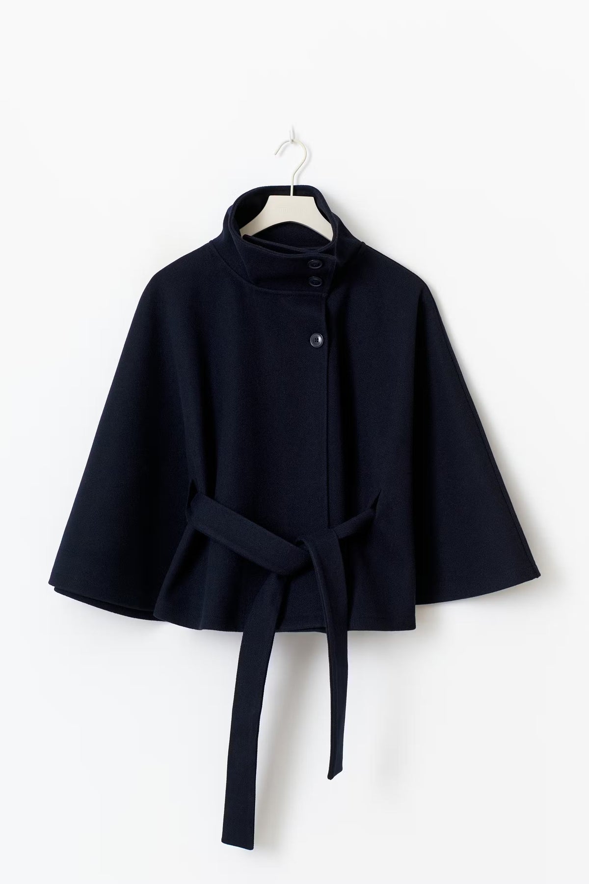 Women’s cape coat with high collar, tie belt, and regular fit
