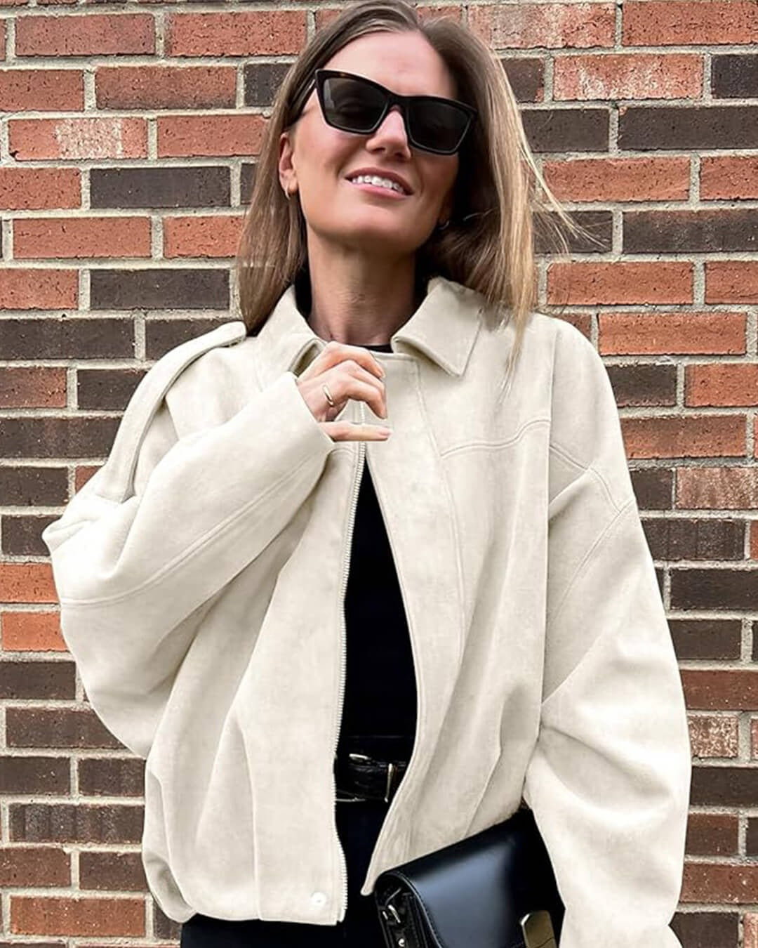 Bomber femme faux daim col structuré finition mate élégante